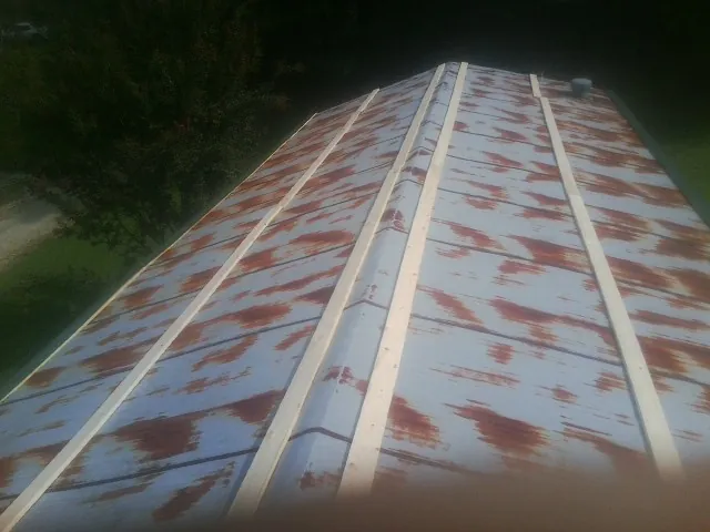 Rusted metal roof panels with new wood purlins before replacement — Storm Damage Roof Repair in Rogersville by Roofing Brothers